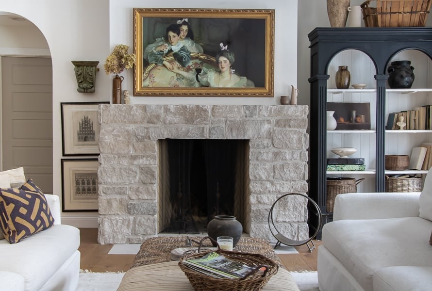 brick fireplace with european style art over it