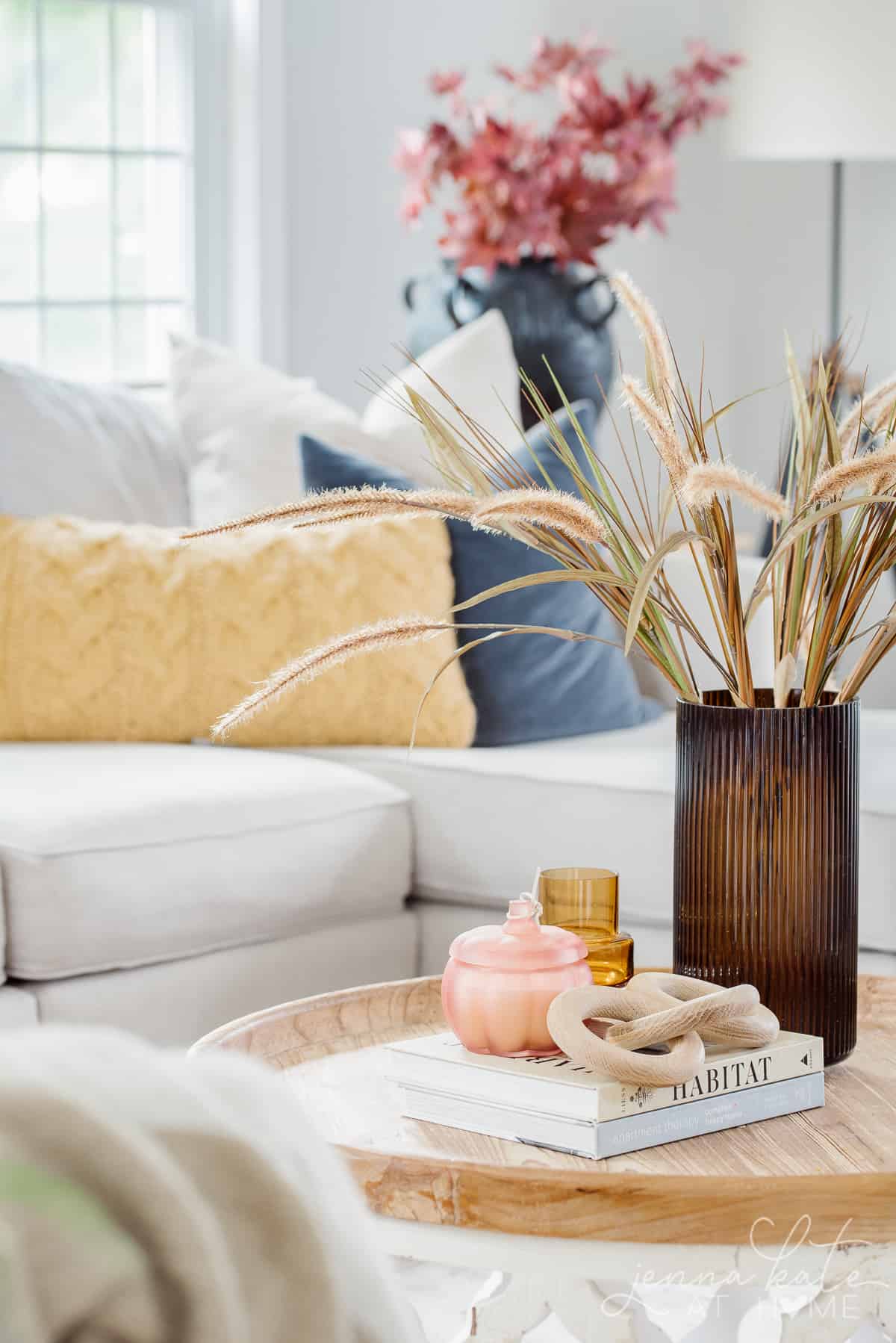 coffee table with amber vase and grass