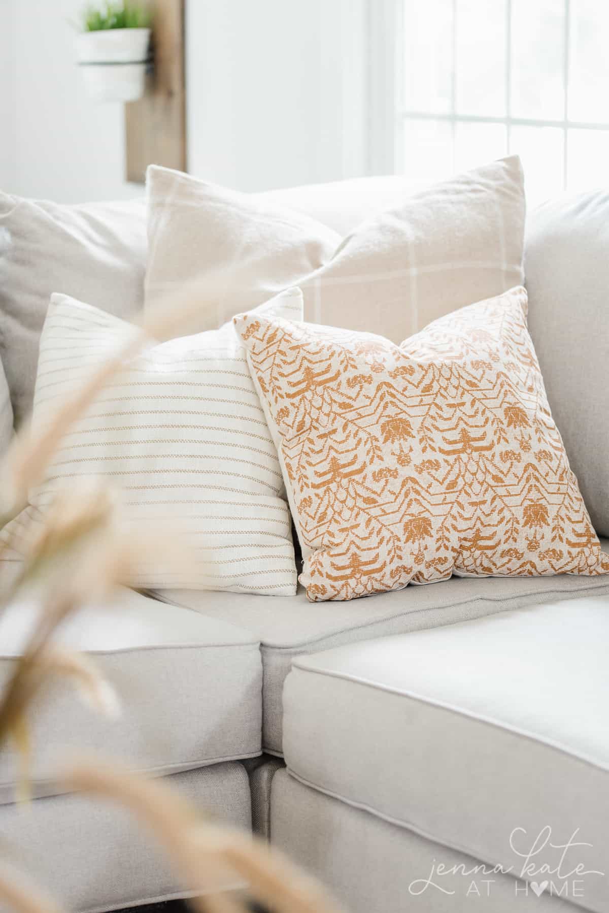A close up shot of the three pillows arranged on the sectional in the living room