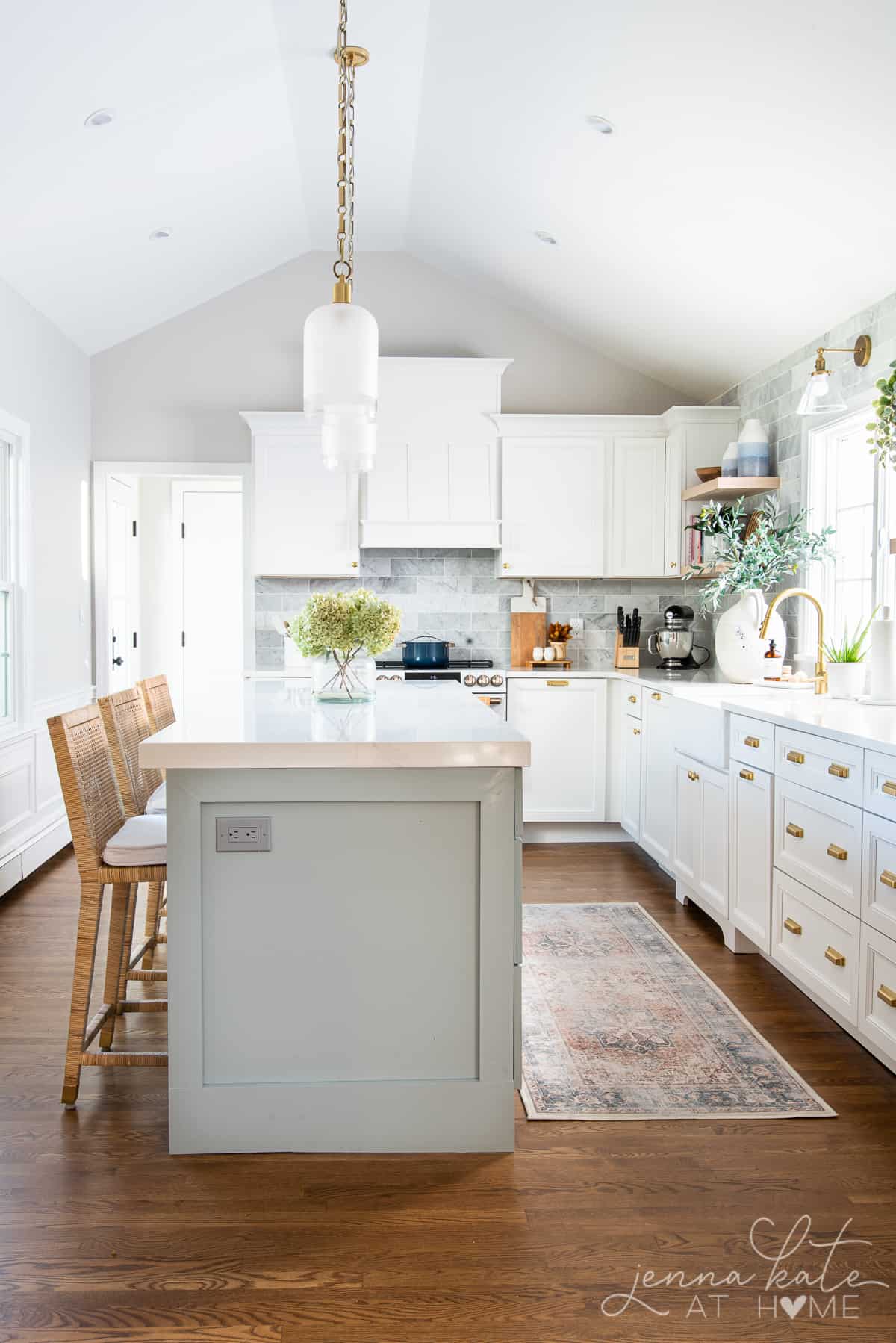 white kitchen with blue gray island and fall accessories on the counters
