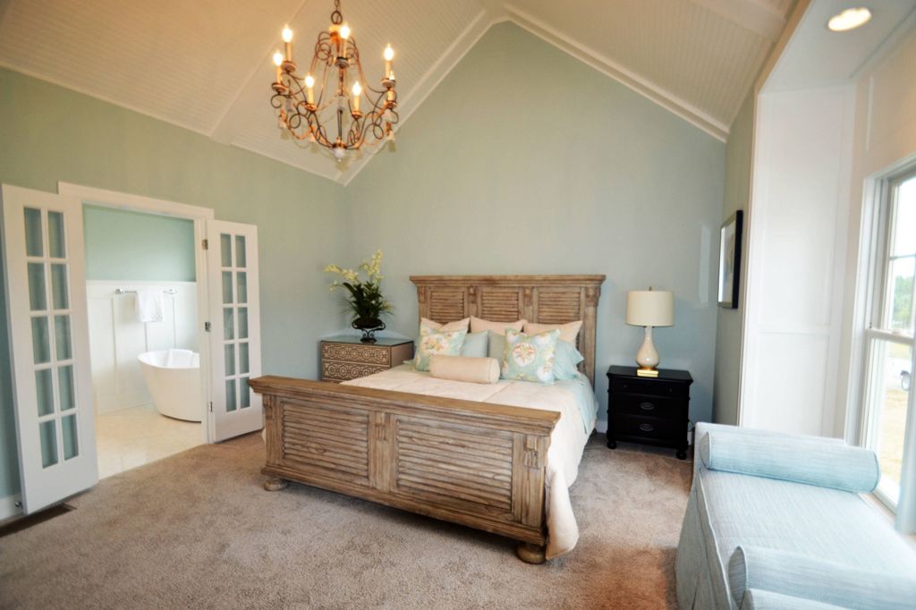 Master bedroom with wooden bed and walls painted Rainwashed