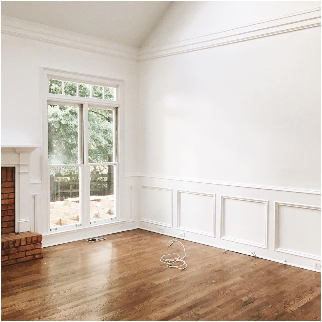 empty living room with wainscoting and walls painted benjamin moore chantilly lace