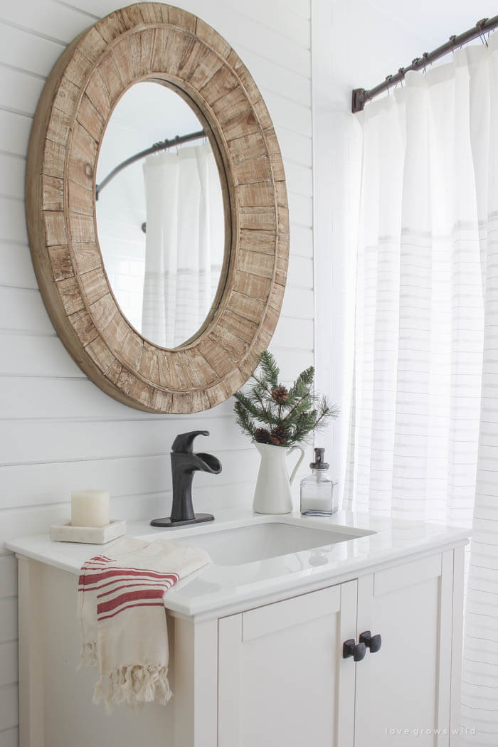 small white bathroom vanity with red striped hand towel on the edge