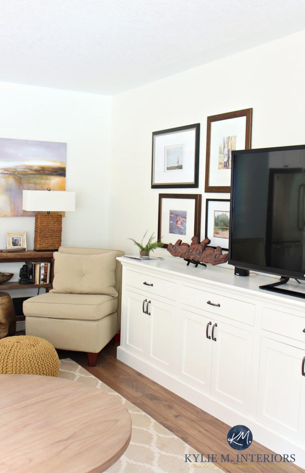 Corner of a living room with a tv unit and accent chair