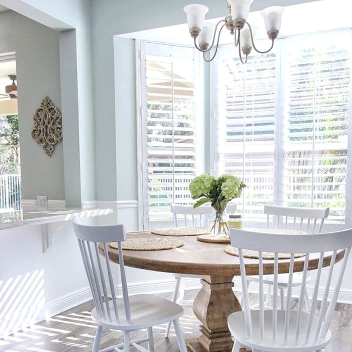 kitchen wood with wood table and white farmhouse chairs view of large bay window