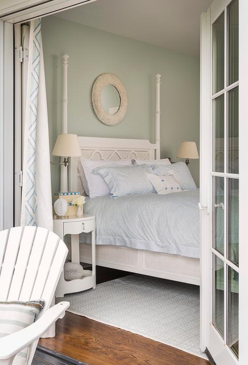 Bedroom with French doors, patio chair, white furniture soft blue bedding