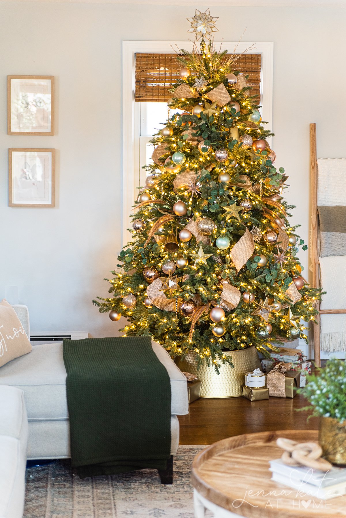 Gold and copper Christmas tree decorations with tree inside a gold hammered metal tree collar