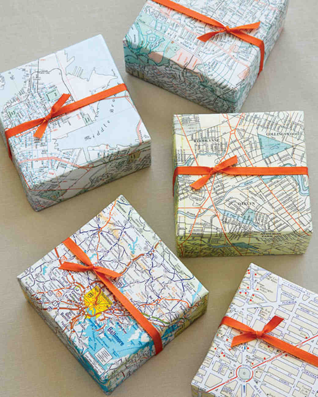 presents wrapped with atlas maps and red ribbons