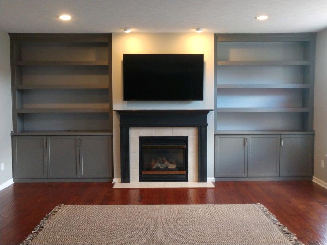 built-ins on either side of the fireplace painted a medium gray color