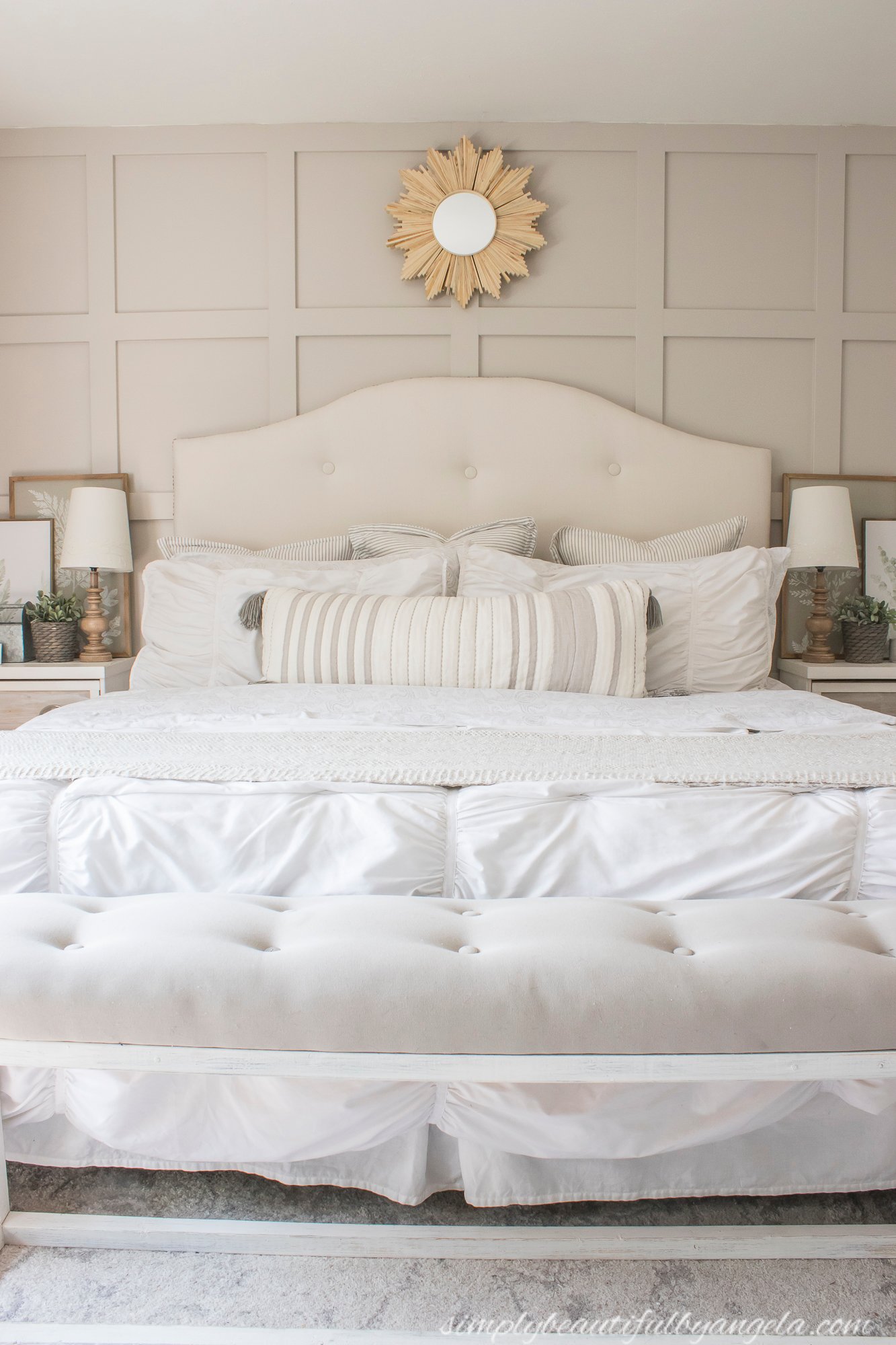 Alpaca painted board and batten walls in a bedroom with a white bed.