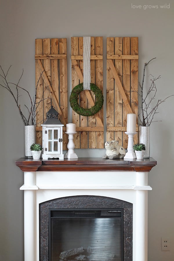 rustic spring mantle wood shutters white accent lantern candlestick and tree branches with pops of green