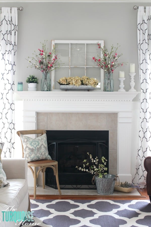 farmhouse mantle with spring vibes pops of green, yellow, and pink florals