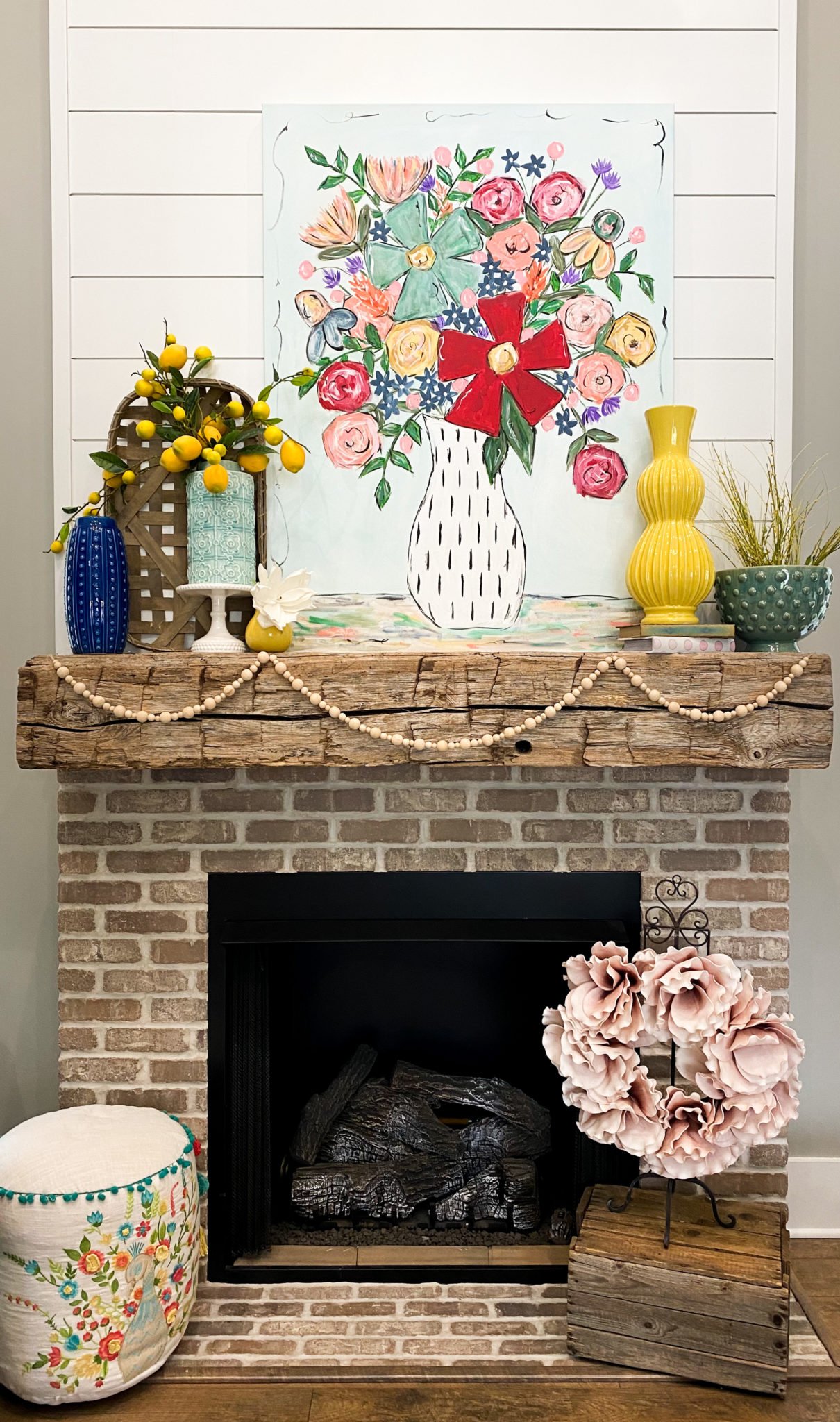 bright spring mantle with colorful artwork yellow florals and vase
