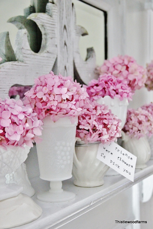 bright pink hydrangea in white vases on spring mantel