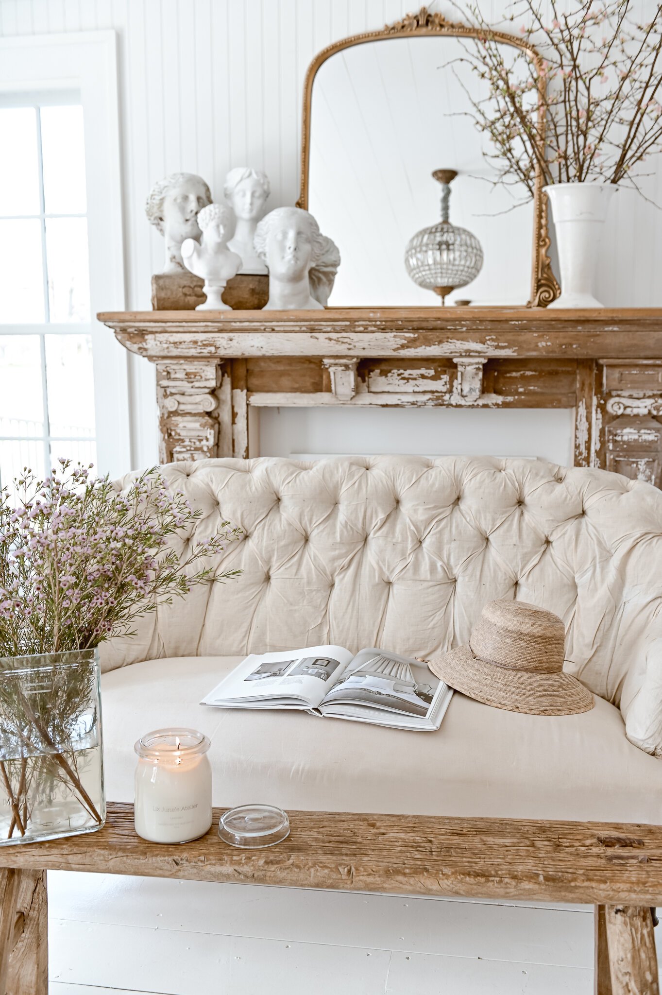 wood and white spring mantel with gold mirror tree branch arrangement and bust planter collection 