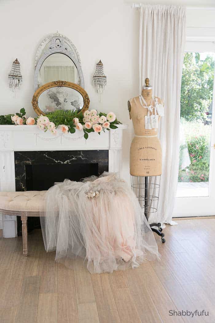 romantic spring mantel with lots of pink florals vintage tule skirt and mannequin 