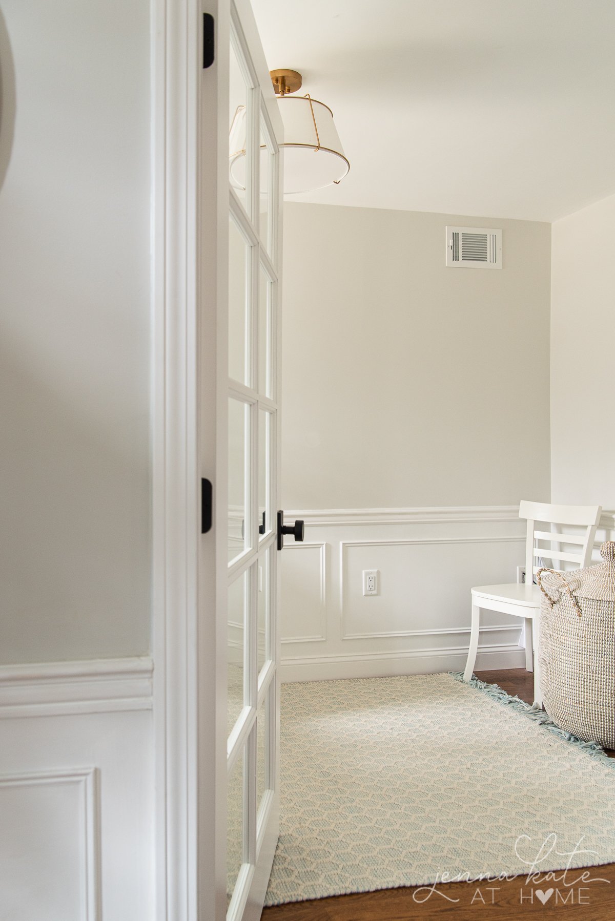 Door open to an office with white board and batten and upper half of walls painted Benjamin Moore Paper White