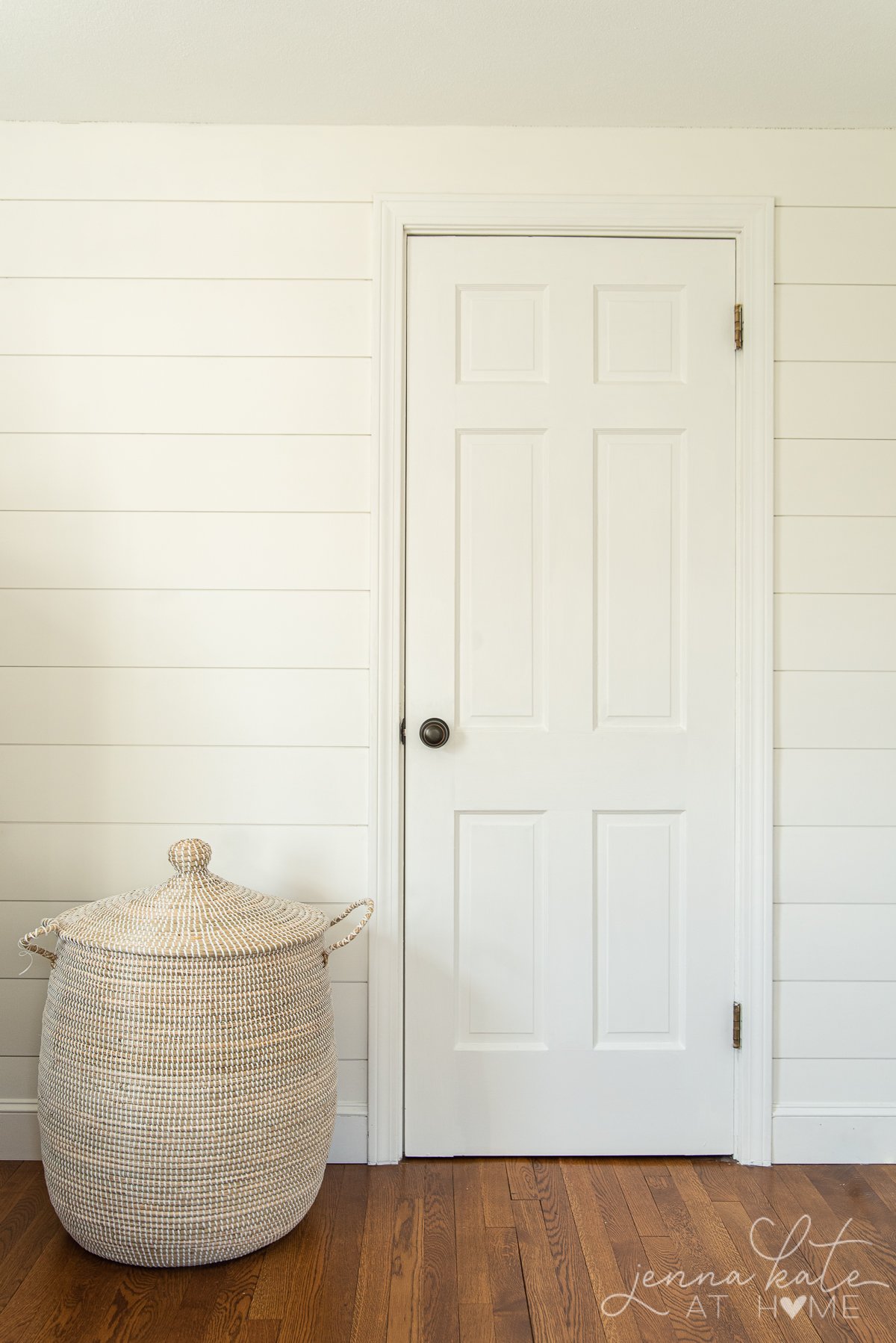 shiplap wall with single closet door all painted simply white