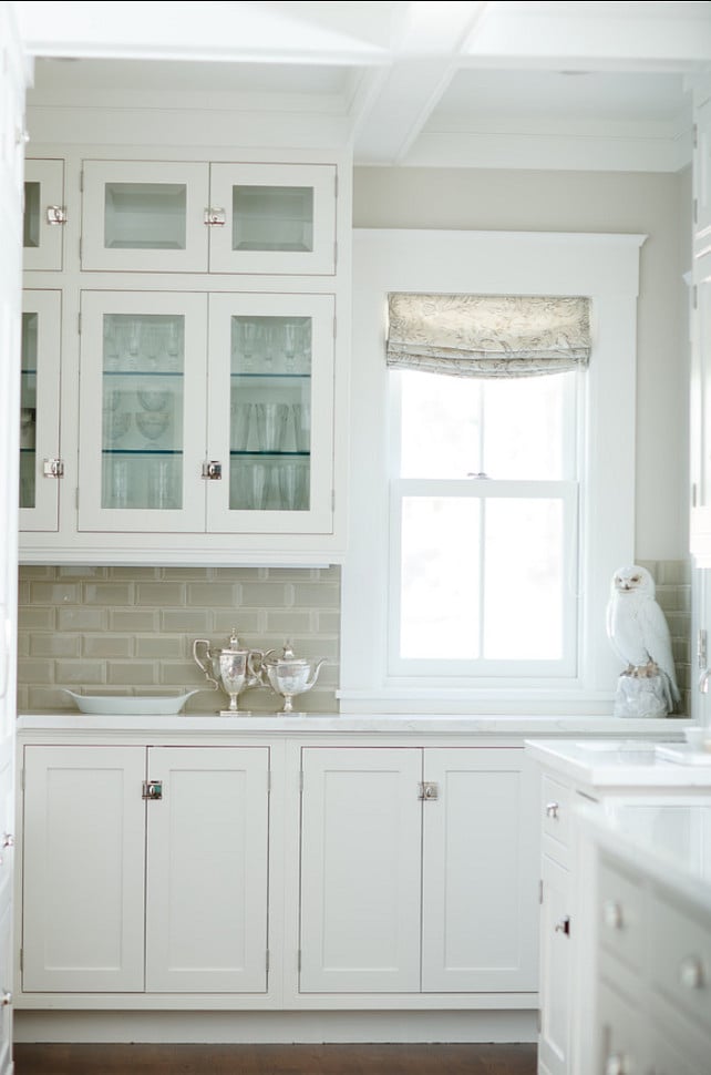 White inset cabinets, beige glass tie backsplash and walls painted Edgecomb Gray