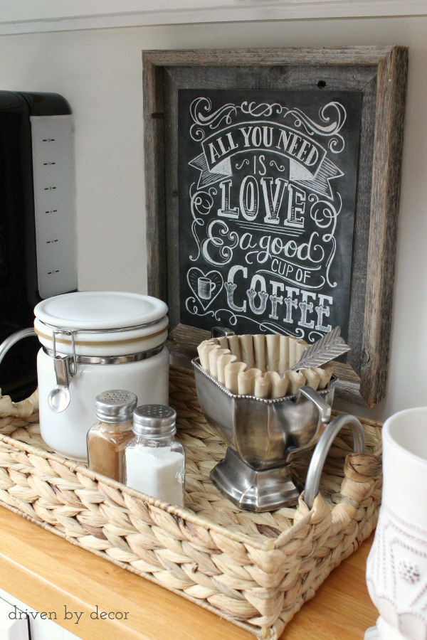 countertop coffee basket with coffee and filters and coffee sign 