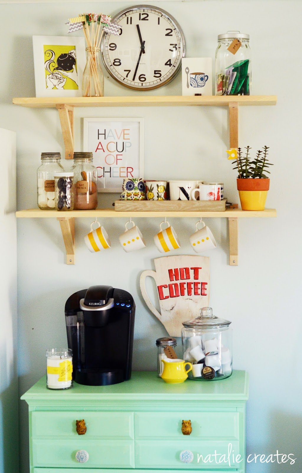colorful coffee bar with green cabinet and wood shelves with pops of yellow and red