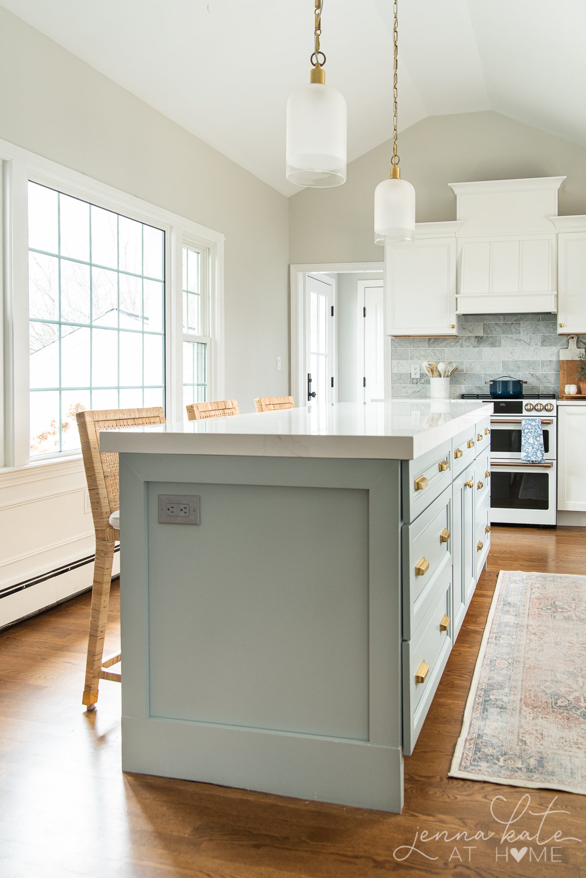 Kitchen with blue island and white cabinets and walls painted Repose Gray