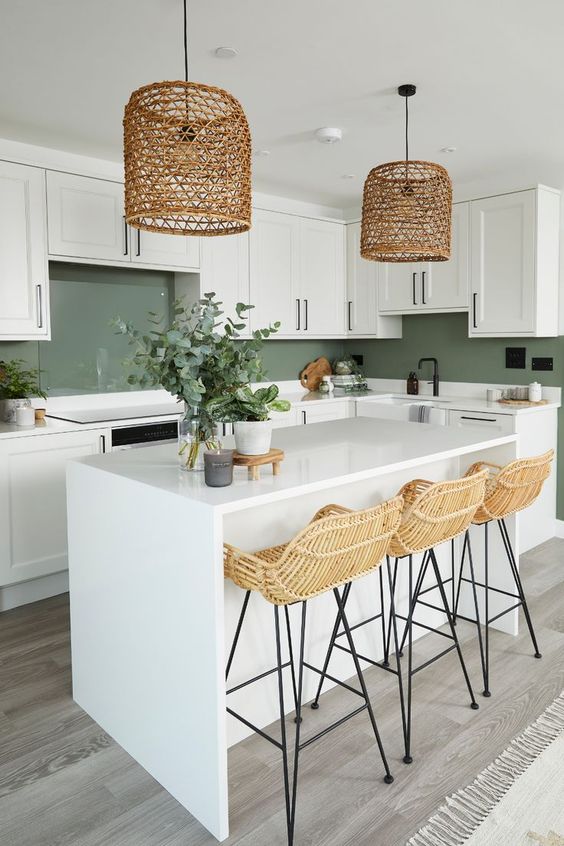 a kitchen island in the middle of a kitchen painted with a dark green paint color