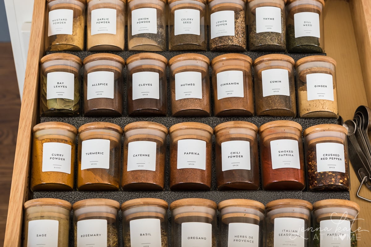 kitchen drawer with organized and labeled spice jars.