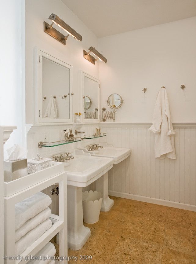 cork floor with twin pedestal sinks white bathroom