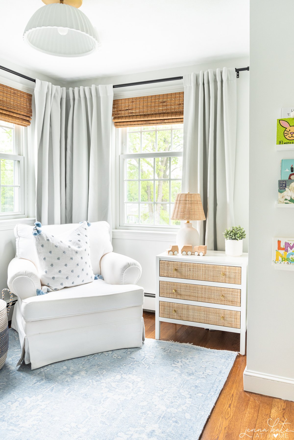 white glider, nightstand and white curtains