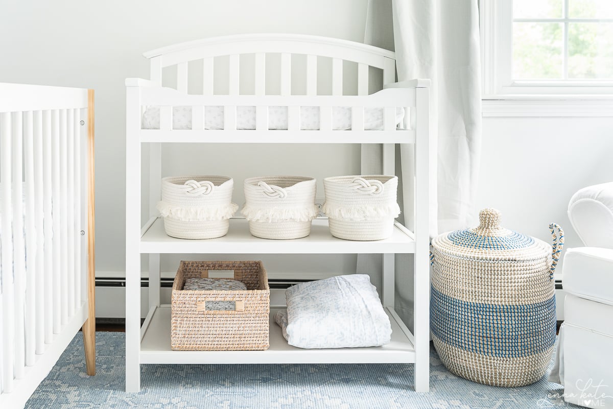 white changing table with cotton baskets