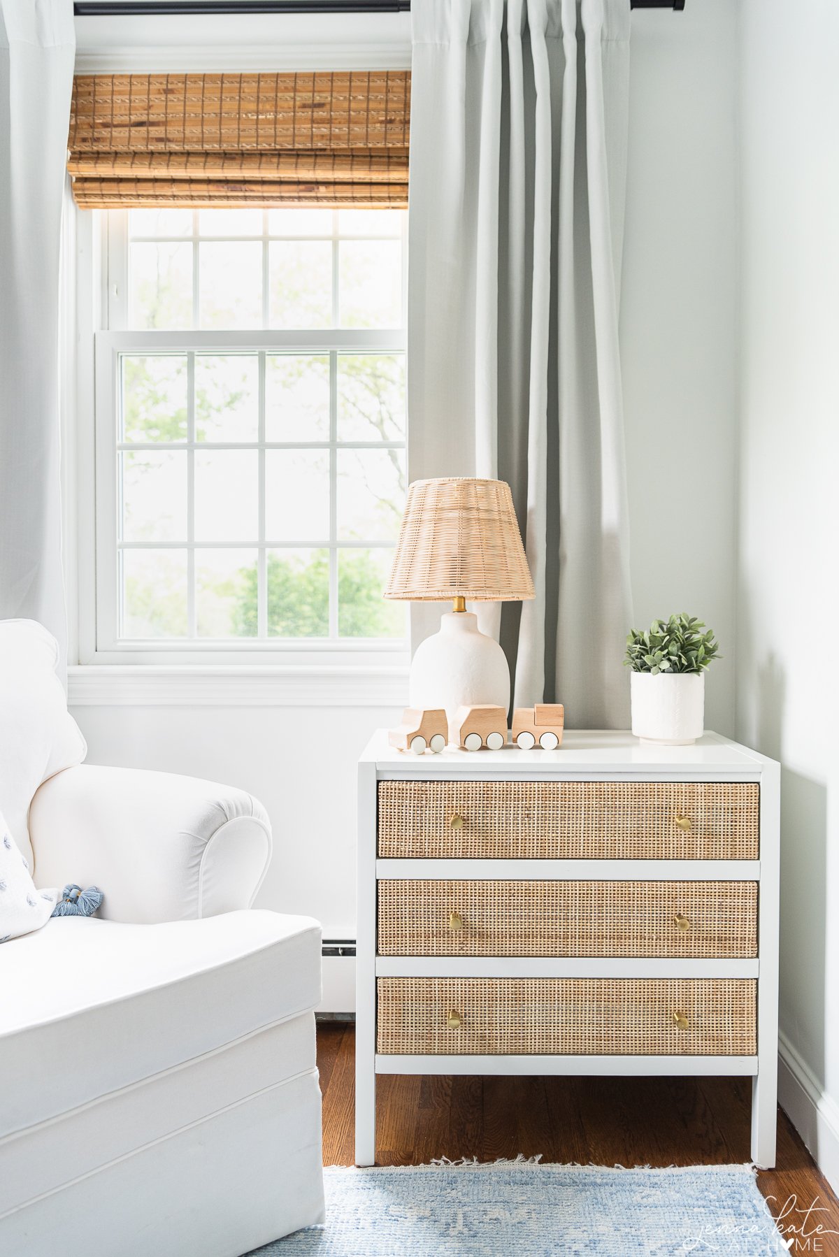 rattan and white nighstand in a bedroom.