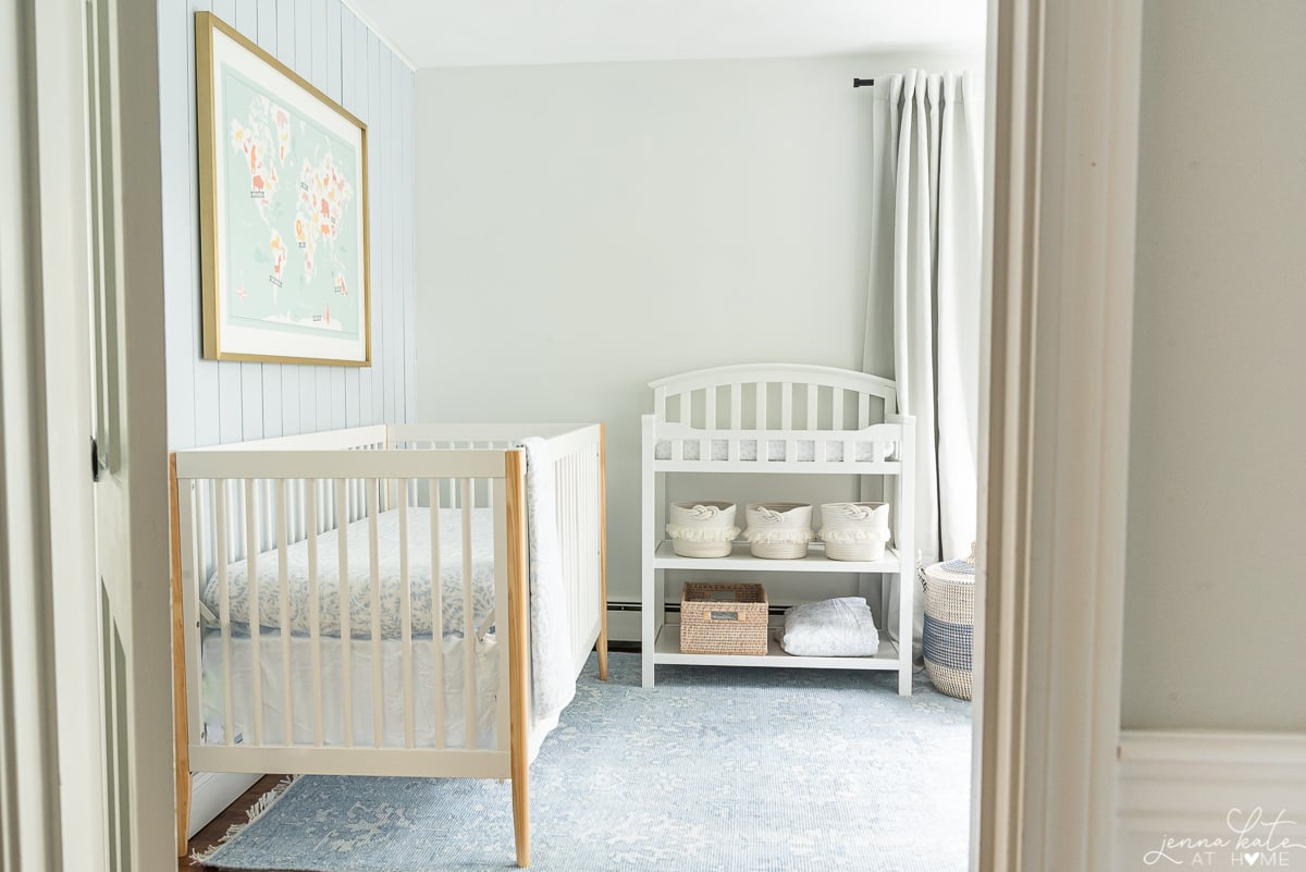 nursery with SW pure white walls and blue rug