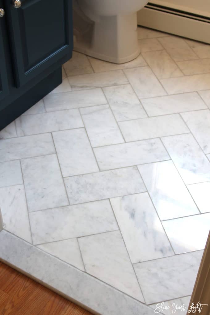 marble herringbone floor in a small bathroom
