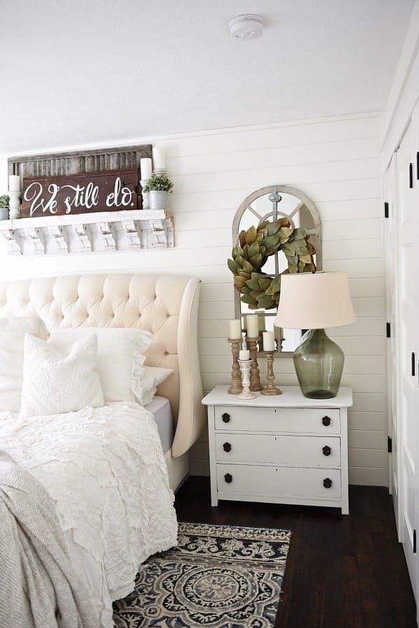 farmhouse style shelf over an upholstered bed