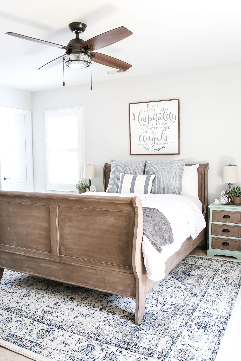 wooden bed with worded sign over it