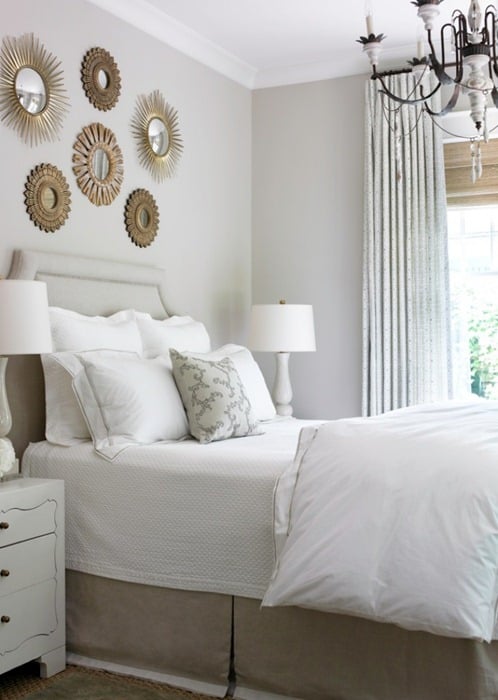 Cluster of mirrors above bed neutral bedroom decor