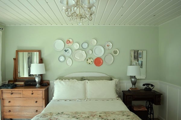 farmhouse bedroom with plate wall gallery wall over the bed