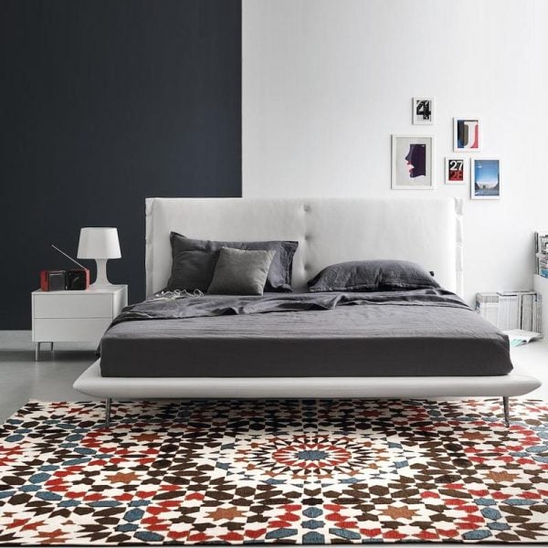 bold patterned rug under a modern style bed