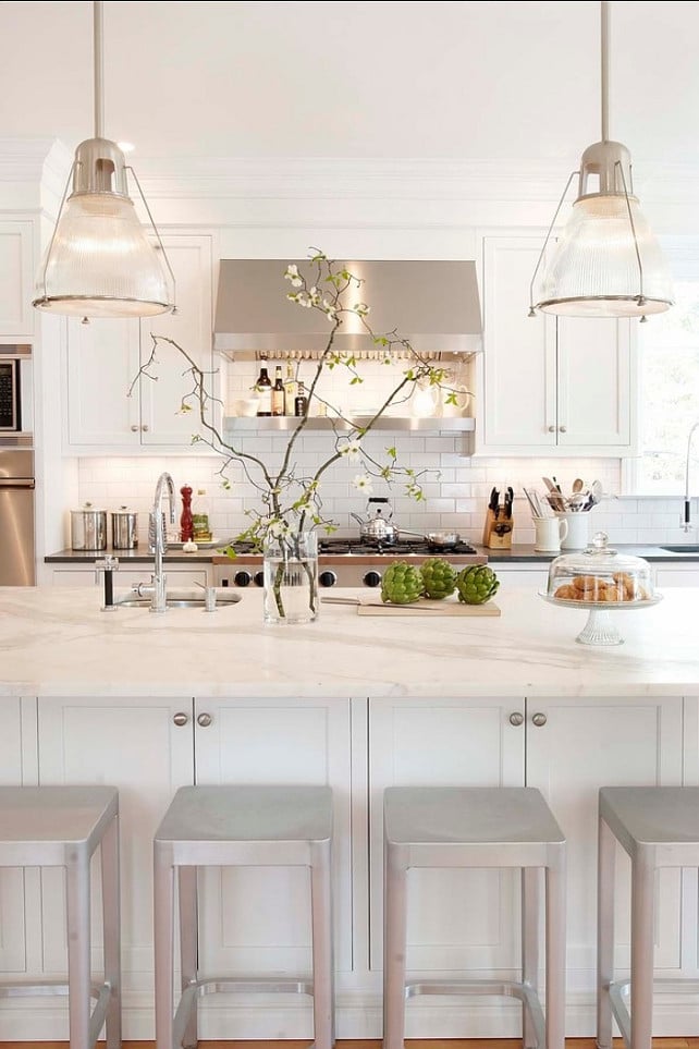 sherwin williams pure white kitchen cabinets with stainless steel range hood and brushed nickel pendant lights