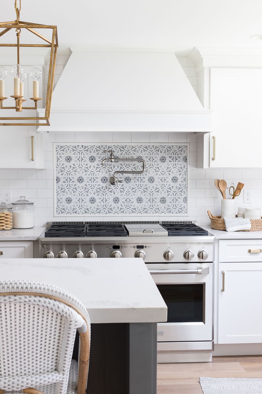 white subway tile with patterned tile pattern over the stove