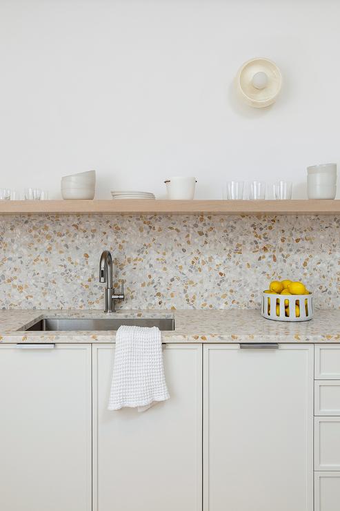 kitchen backsplash made from recycled glass that goes with white cabinets