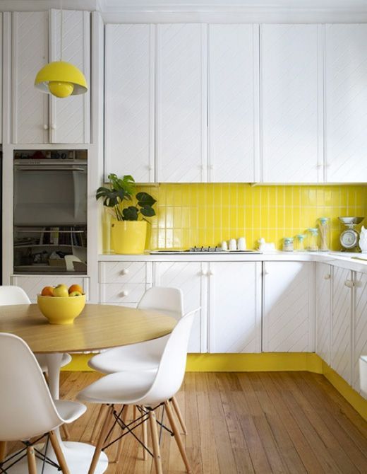 bright yellow vertical tile kitchen backsplash with white cabinets