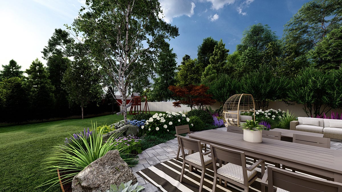 our back patio with a. large table and chairs surrounded by various plants