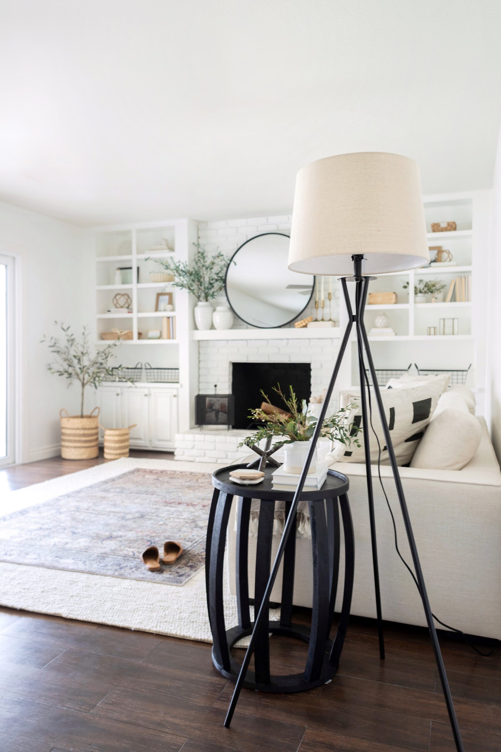 a large lamp beside a coffee table in a living room