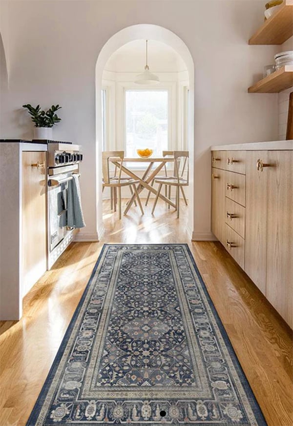 dark blue runner in a kitchen with an arched opening to dining space