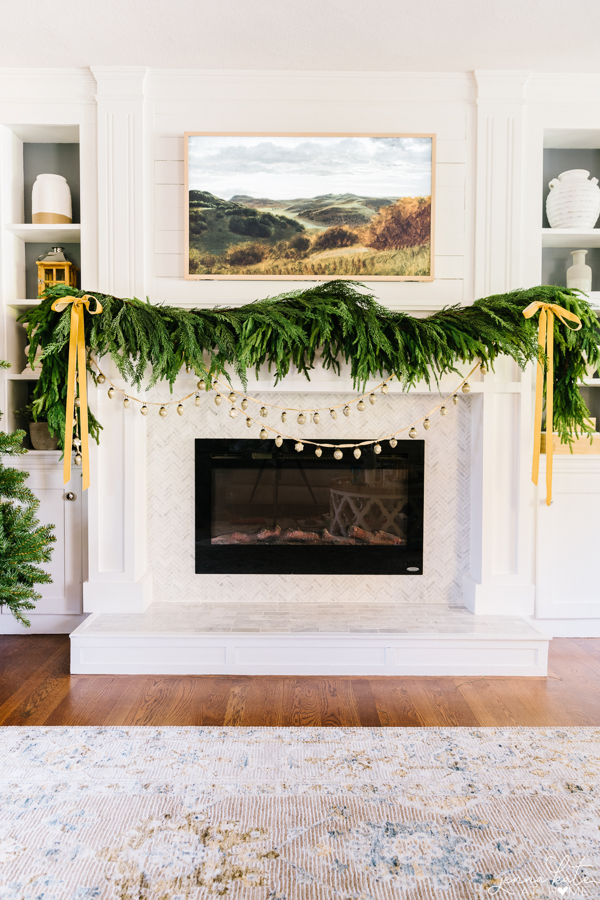 gold ribbon attached the garland on a fireplace mantel