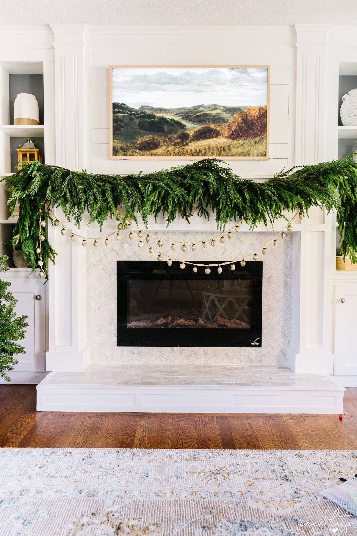 faux garland hung on the mantel with a ornament garland below