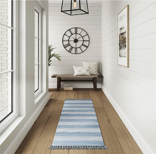 blue striped runner rug in a hallway with shiplap walls
