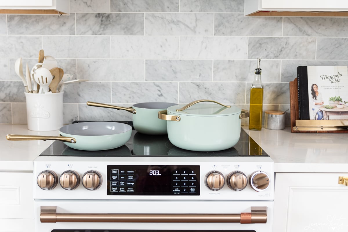 mint green Caraway Cookware on a stovetop